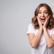 Wow - surprised young woman with hands on face expressing amazement isolated on gray background Wow - surprised young woman with hands on face expressing amazement isolated on gray background - PhotoDune Item for Sale