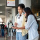 Asian tourist couple go on trip woman looking at man's phone as standing waiting for taxi in airport Asian tourist couple go on trip woman looking at man's phone as standing waiting for taxi in airport - PhotoDune Item for Sale