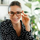 Close-up portrait of a beautiful caucasian businesswoman in a shirt and glasses, sitting at the desk Close-up portrait of a beautiful caucasian businesswoman in a shirt and glasses, sitting at the desk - PhotoDune Item for Sale