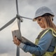 A skilled female engineer analyzes data at a wind turbine site, demonstrating her expertise in A skilled female engineer analyzes data at a wind turbine site, demonstrating her expertise in - PhotoDune Item for Sale
