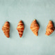 Croissants Arranged in Minimal Vertical Line on Pastel Background Croissants Arranged in Minimal Vertical Line on Pastel Background - PhotoDune Item for Sale