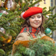 A woman in a red clothes with a bouquet of fir branches walks along the Christmas decorated streets A woman in a red clothes with a bouquet of fir branches walks along the Christmas decorated streets - PhotoDune Item for Sale