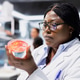 Close up of molecular biologist in lab checking bacterial growth on petri dish Close up of molecular biologist in lab checking bacterial growth on petri dish - PhotoDune Item for Sale