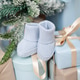 Blue booties among the gifts under the Christmas tree. Blue booties among the gifts under the Christmas tree. - PhotoDune Item for Sale
