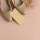 Beige High Heels with Roses and Gift Tag on Peach Background Beige High Heels with Roses and Gift Tag on Peach Background - PhotoDune Item for Sale