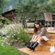 Woman putting on rubber boots on wooden porch in garden, countryside lifestyle Woman putting on rubber boots on wooden porch in garden, countryside lifestyle - PhotoDune Item for Sale