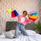pretty happy woman jumping on bed at home shopping online pretty happy woman jumping on bed at home shopping online - PhotoDune Item for Sale