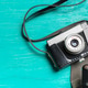 Vintage camera rests on a bright wooden table surrounded by empty space Vintage camera rests on a bright wooden table surrounded by empty space - PhotoDune Item for Sale