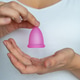 Reusable Menstrual Cup in Female Hands Reusable Menstrual Cup in Female Hands - PhotoDune Item for Sale