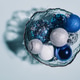 Shiny Christmas balls of blue, silver and white lie in a plate Shiny Christmas balls of blue, silver and white lie in a plate - PhotoDune Item for Sale