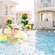 Little boy has a fun with pink ball on swimming pool. Little boy has a fun with pink ball on swimming pool. - PhotoDune Item for Sale