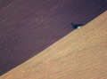 Aerial photo of a tractor ploughing a field in a countryside Aerial photo of a tractor ploughing a field in a countryside - PhotoDune Item for Sale