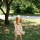 Little girl 3 years old in a summer sundress in the park. Summer time. Little girl 3 years old in a summer sundress in the park. Summer time. - PhotoDune Item for Sale