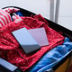 opened packed suitcase on bed in hotel room with smartphone screen opened packed suitcase on bed in hotel room with smartphone screen - PhotoDune Item for Sale