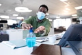 Businessman wearing face mask sanitizing his hands at modern office Businessman wearing face mask sanitizing his hands at modern office - PhotoDune Item for Sale
