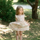 Little girl 3 years old in a summer sundress in the park. Summer time. Little girl 3 years old in a summer sundress in the park. Summer time. - PhotoDune Item for Sale