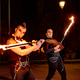 Fire dancers performing with burning swords at night Fire dancers performing with burning swords at night - PhotoDune Item for Sale