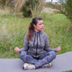 A woman doing morning energy exercises in the lotus position in a park. Doing yoga A woman doing morning energy exercises in the lotus position in a park. Doing yoga - PhotoDune Item for Sale