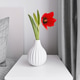 Red tulip in a white ceramic vase on a bedside table. Bedroom interior Red tulip in a white ceramic vase on a bedside table. Bedroom interior - PhotoDune Item for Sale