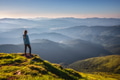 Girl on mountain peak looking at beautiful mountains at sunset Girl on mountain peak looking at beautiful mountains at sunset - PhotoDune Item for Sale