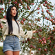 Smiling beauty walking through apple orchard, looking ahead. Smiling beauty walking through apple orchard, looking ahead. - PhotoDune Item for Sale