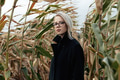 Stylish woman in black coat and glasses in autumn corn field Stylish woman in black coat and glasses in autumn corn field - PhotoDune Item for Sale