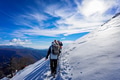 Group of mountain hikers in single file go up the snowy peak. Group of mountain hikers in single file go up the snowy peak. - PhotoDune Item for Sale