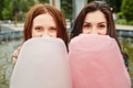 Two sisters eating cotton candy at the park Two sisters eating cotton candy at the park - PhotoDune Item for Sale