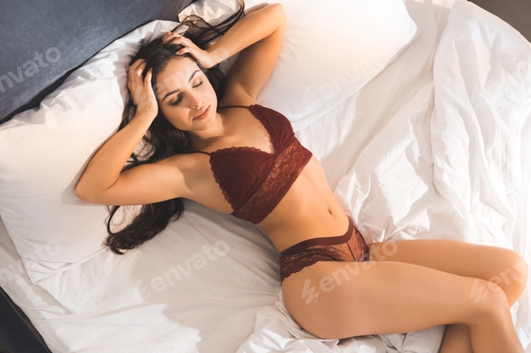 beautiful sexy woman in lingerie with hands on head sleeping in bed at home in morning Stock Photo by LightFieldStudios beautiful sexy woman in lingerie with hands on head sleeping in bed at home in morning Stock Photo by LightFieldStudios