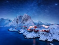 Milky Way and stars trails. View on the house in the Hamnoy village, Lofoten Islands, Norway. Milky Way and stars trails. View on the house in the Hamnoy village, Lofoten Islands, Norway. - PhotoDune Item for Sale