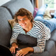 Young man relaxing on sofa at home working on laptop Young man relaxing on sofa at home working on laptop - PhotoDune Item for Sale