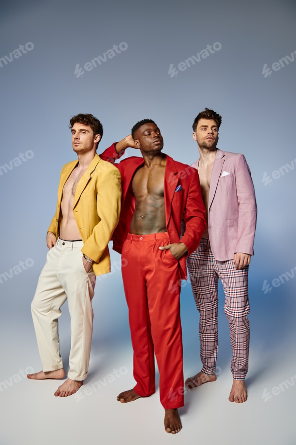 appealing sexy diverse men in unbuttoned vibrant suits posing on gray backdrop, fashion concept Stock Photo by LightFieldStudios appealing sexy diverse men in unbuttoned vibrant suits posing on gray backdrop, fashion concept Stock Photo by LightFieldStudios