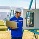 Worker checks solar panel system in green energy field during sunny day to ensure proper functioning Worker checks solar panel system in green energy field during sunny day to ensure proper functioning - PhotoDune Item for Sale