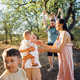 Family enjoying a sunny day outdoors, with children playing joyfully Family enjoying a sunny day outdoors, with children playing joyfully - PhotoDune Item for Sale