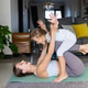 Mother and daughter playing together on a yoga mat in a living room Mother and daughter playing together on a yoga mat in a living room - PhotoDune Item for Sale