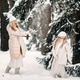 Handsome mother and daughter are having fun outdoor in winter time. Playing with snow in forest Handsome mother and daughter are having fun outdoor in winter time. Playing with snow in forest - PhotoDune Item for Sale