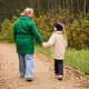 Walking mother with daughter on park path. Holding hands shows parenting, care, trust, safety Walking mother with daughter on park path. Holding hands shows parenting, care, trust, safety - PhotoDune Item for Sale