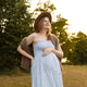 Pregnant woman in summer dress enjoying nature outdoors Pregnant woman in summer dress enjoying nature outdoors - PhotoDune Item for Sale
