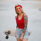 Cute blonde lady with tattooed arms in red glasses, red T-shirt and denim shorts Cute blonde lady with tattooed arms in red glasses, red T-shirt and denim shorts - PhotoDune Item for Sale