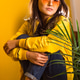 a teenager sits in a yellow sweater and yellow glasses a teenager sits in a yellow sweater and yellow glasses - PhotoDune Item for Sale