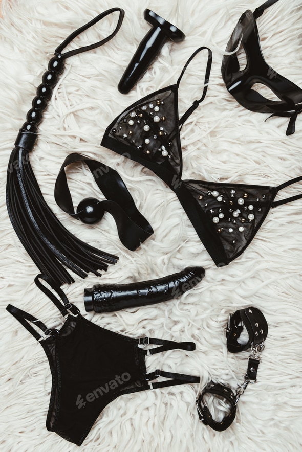 Black adult toys and bdsm equipment with lingerie on carpet Stock Photo by LightFieldStudios Black adult toys and bdsm equipment with lingerie on carpet Stock Photo by LightFieldStudios