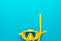 yellow diving mask and snorkel over blue background with copy space yellow diving mask and snorkel over blue background with copy space - PhotoDune Item for Sale