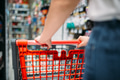 Female customer with cart in food store, back view Female customer with cart in food store, back view - PhotoDune Item for Sale