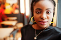 Close up portrait african woman in black blouse at cafe. Close up portrait african woman in black blouse at cafe. - PhotoDune Item for Sale