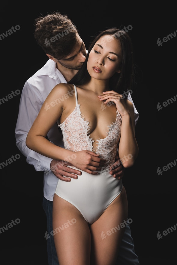 handsome young man embracing and kissing attractive asian girlfriend in white lingerie isolated on Stock Photo by LightFieldStudios handsome young man embracing and kissing attractive asian girlfriend in white lingerie isolated on Stock Photo by LightFieldStudios