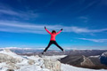Woman hiker in the mountains jumps happy in the blue sky Woman hiker in the mountains jumps happy in the blue sky - PhotoDune Item for Sale