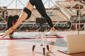 Young sporty fit woman coach doing online lessons through video call on her mobile phone Young sporty fit woman coach doing online lessons through video call on her mobile phone - PhotoDune Item for Sale