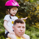 Cheerful father holds his daughter on his shoulders in the park. Cheerful father holds his daughter on his shoulders in the park. - PhotoDune Item for Sale