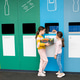 Girls taking out plastic trash in recycling centre. National recycling week. Girls taking out plastic trash in recycling centre. National recycling week. - PhotoDune Item for Sale