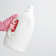 Female hand wearing pink rubber glove holding white laundry gel packaging mockup Female hand wearing pink rubber glove holding white laundry gel packaging mockup - PhotoDune Item for Sale